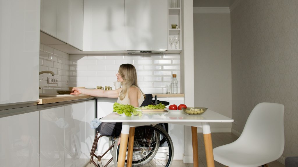 person in wheelchair in a kitchen