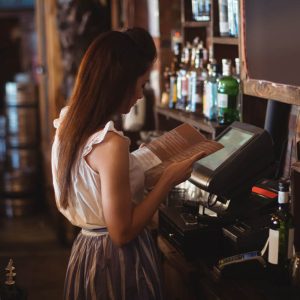 Bar person looking at the menu
