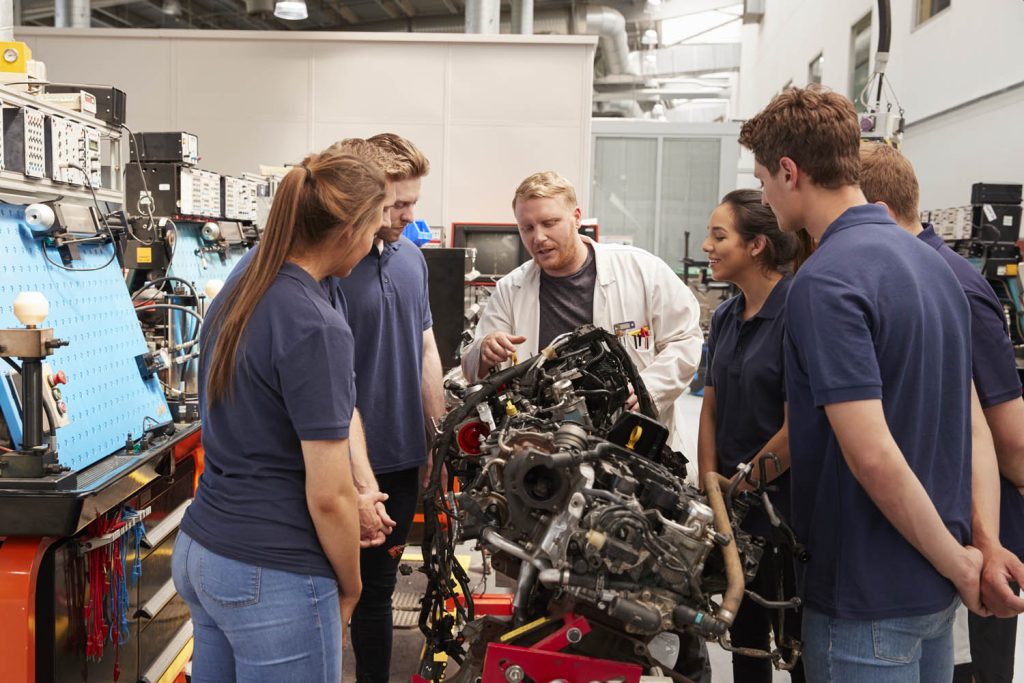 Lecture teaching learners in automotive workshop