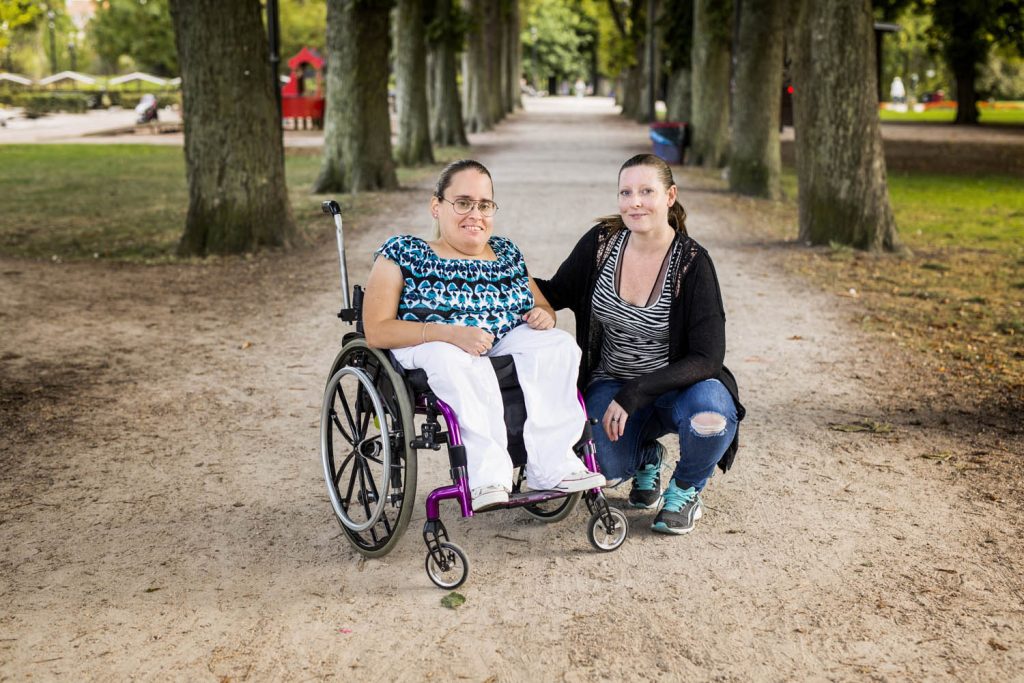 Woman in wheelchair with carer