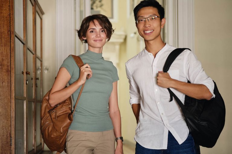 Two learners wearing carrying rucksacks