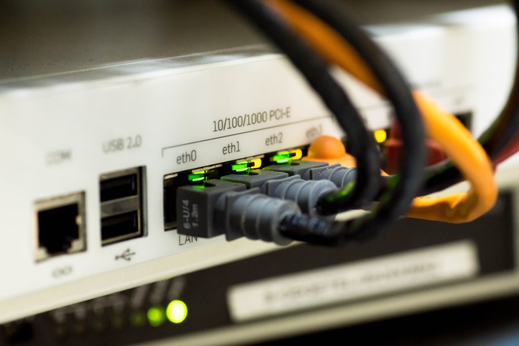 close up of back of router with network cables attached