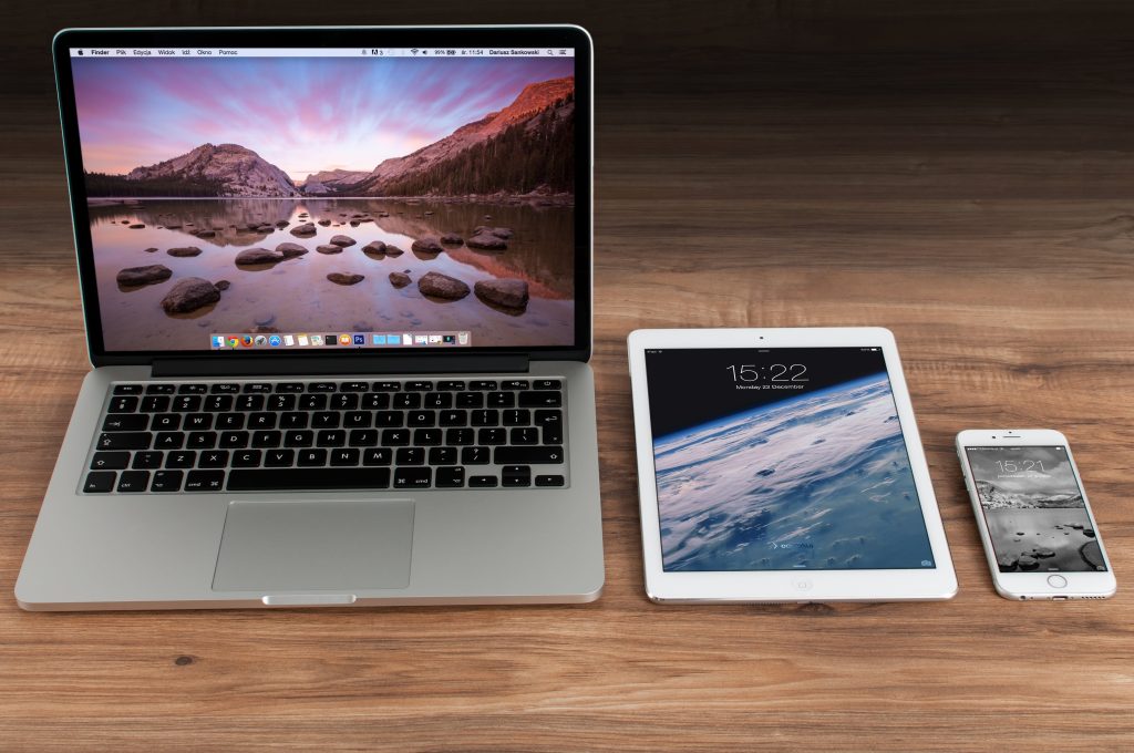 A laptop, iPad and phone on a table