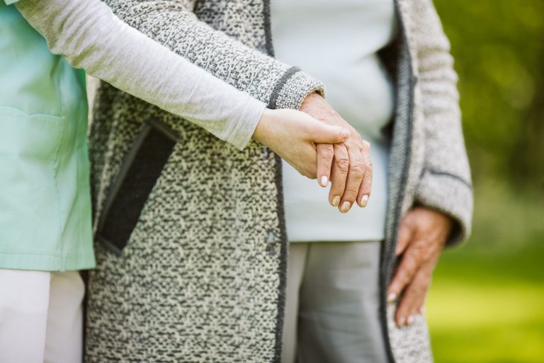 Young hand holding and helping an elder.